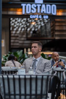 Businessman wearing suit inside Tostado Café, with focus on professional setting.