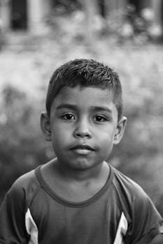 Captivating black and white portrait of a young boy outdoors in Breves, Brazil.